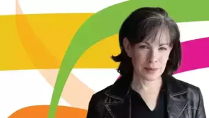A woman with short, dark hair and a gentle smile wears a black leather jacket, looking directly forward.